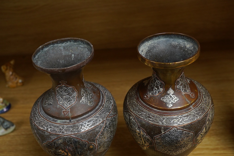 A pair of Cairoware silver and copper inlaid brass vases, 24cm high